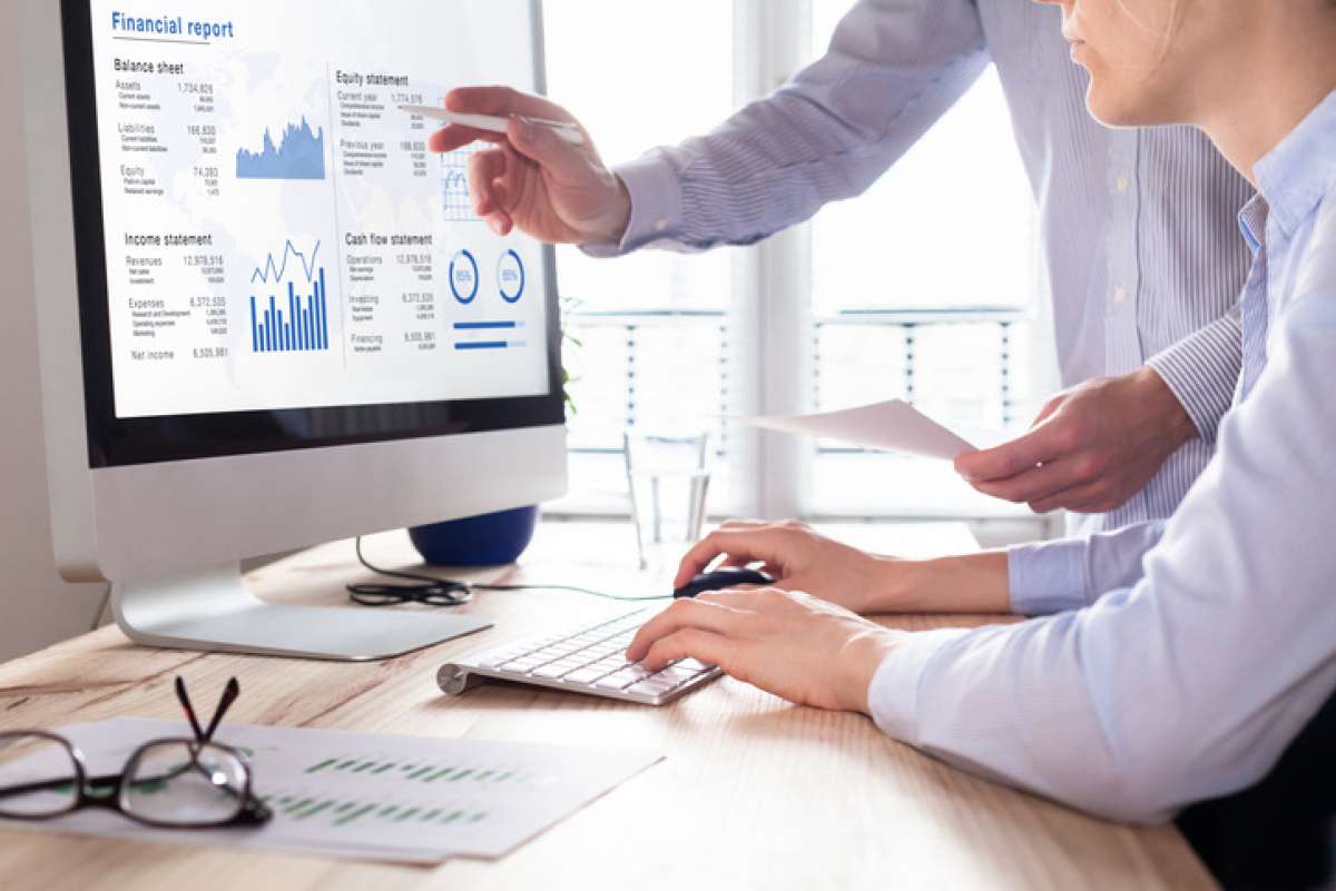 Man at computer looking at financial reports